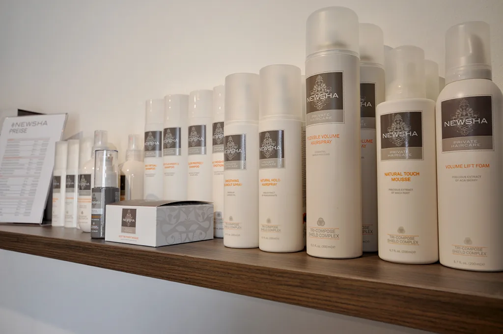 Pflegeprodukte auf einem Wandregal im Salon